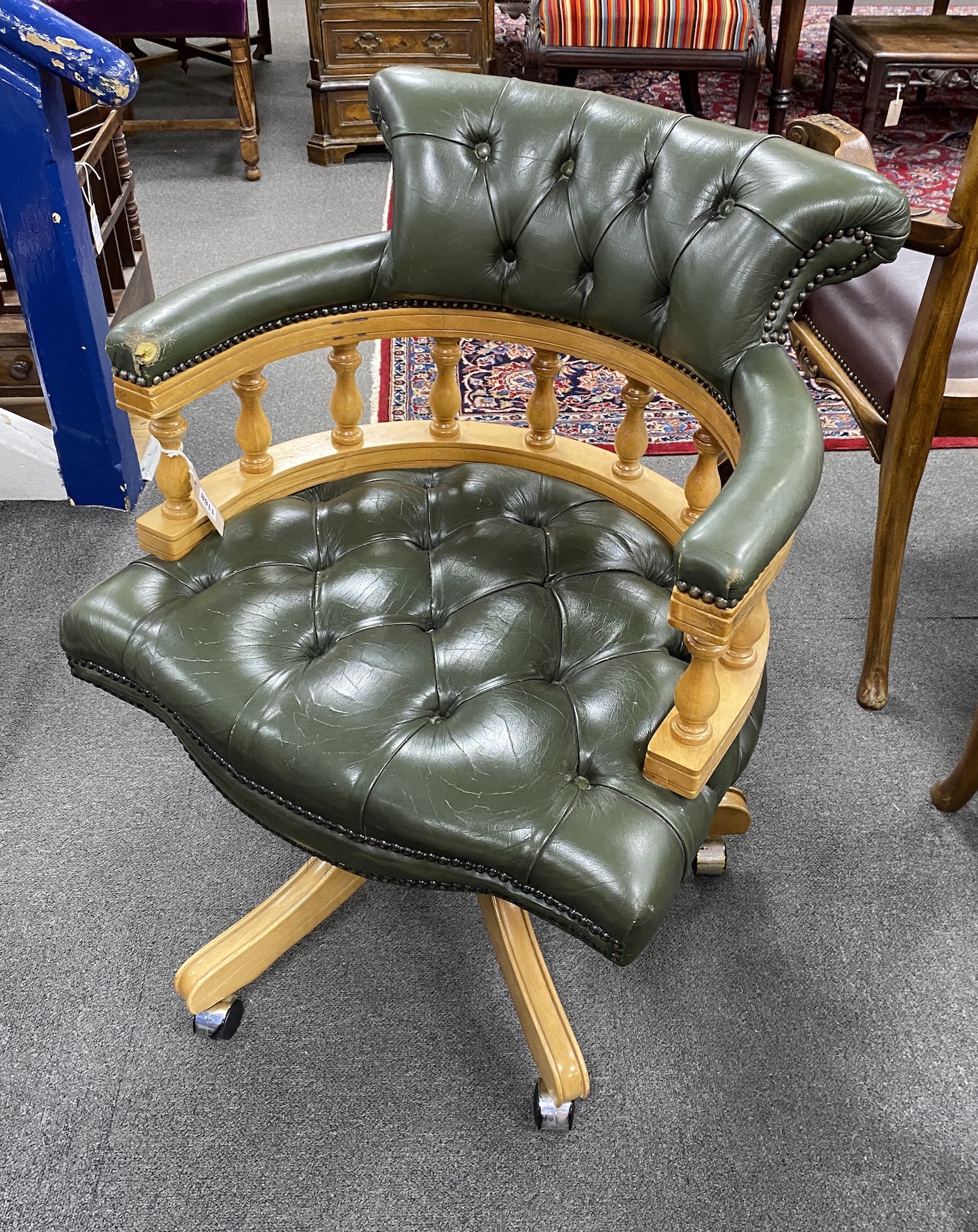 A reproduction buttoned green leather pale mahogany swivel 'captain's' desk chair, width 63cm, height 78cm